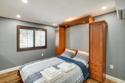 a bedroom with a large bed with a wooden headboard at Hidden Gem in Hawthorne about 3 Mi to SoFi Stadium in Hawthorne