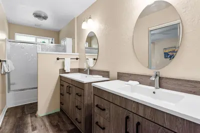 a bathroom with two sinks and a mirror at Paramount Paradise in Big Bear Lake