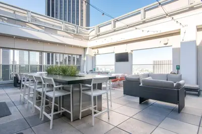 a large room with a table and chairs and windows at Downtown 1BR w Gym WD next to The Broad LAX-51 in Los Angeles