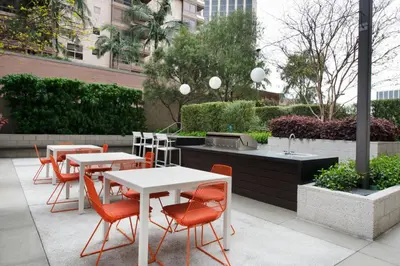 a patio with tables and chairs and a grill at Downtown 1BR w Gym WD next to The Broad LAX-51 in Los Angeles