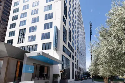 a white building on a city street with trees at Downtown 1BR w Gym WD next to The Broad LAX-51 in Los Angeles