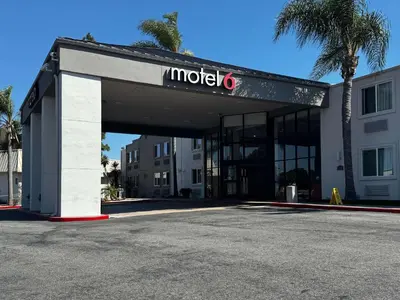 a hotel with a sign on top of a building at Studio 6 Suites Carson, CA in Carson