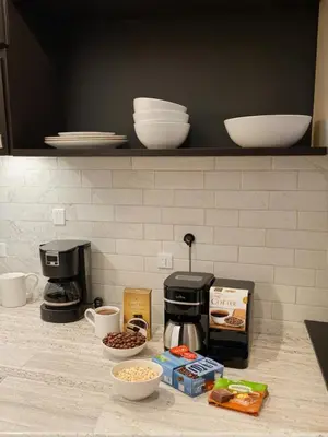 a kitchen counter with a coffee maker and some food at Glamorous KTown Boutique Residences with Rooftop view in Los Angeles