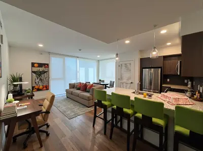 a kitchen and living room with a table and chairs at Glamorous KTown Boutique Residences with Rooftop view in Los Angeles