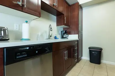 a kitchen with wooden cabinets and a dishwasher at Lovely and cozy apartment- Rancho in Rancho Palos Verdes