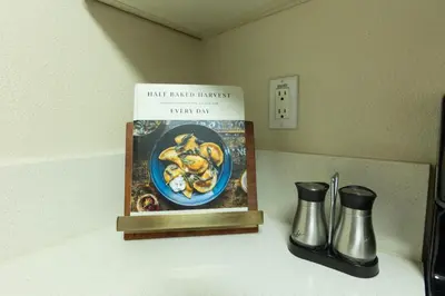 a kitchen counter with a book and two vases at Lovely and cozy apartment- Rancho in Rancho Palos Verdes