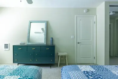 a bedroom with two beds and a dresser with a mirror at Lovely and cozy apartment- Rancho in Rancho Palos Verdes