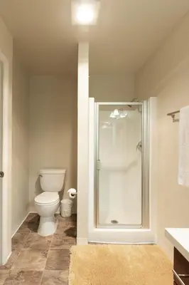 a bathroom with a toilet and a glass shower at Lovely and cozy apartment- Rancho in Rancho Palos Verdes