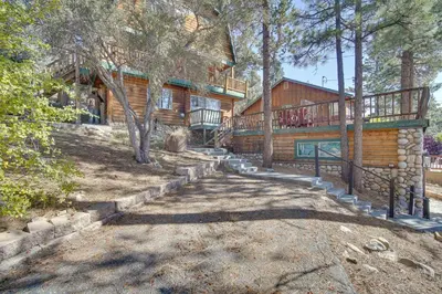 a log cabin with a staircase leading to a house at Quaint Big Bear Home with Hot Tub 4 Mi to Skiing! in Big Bear City