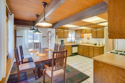 a kitchen and dining room with a table and chairs at Quaint Big Bear Home with Hot Tub 4 Mi to Skiing! in Big Bear City