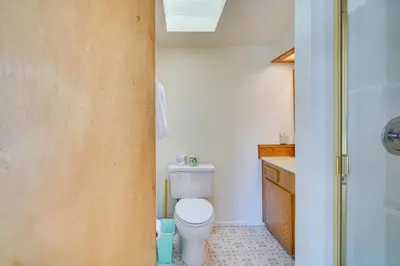 a bathroom with a toilet and a shower at Quaint Big Bear Home with Hot Tub 4 Mi to Skiing! in Big Bear City