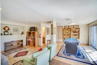 a living room with a couch and a table at Quaint Big Bear Home with Hot Tub 4 Mi to Skiing! in Big Bear City