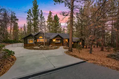 a log home in the woods with a driveway at Big Bear Villa - Walk to Lake ad Village! Hot Tub, Jet Tub and so much more! in Big Bear Lake
