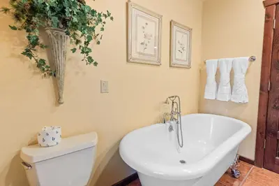 a bathroom with a white toilet and a sink at Big Bear Villa - Walk to Lake ad Village! Hot Tub, Jet Tub and so much more! in Big Bear Lake