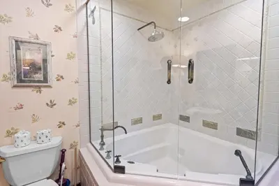 a bathroom with a tub and a toilet at Big Bear Villa - Walk to Lake ad Village! Hot Tub, Jet Tub and so much more! in Big Bear Lake