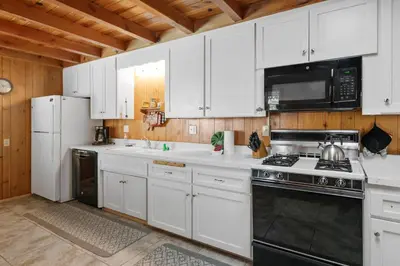 a kitchen with white cabinets and a stove top oven at Kapers - Located in a beautiful quiet area of Big Bear Lake, walking distance to Snow Summit! in Big Bear Lake