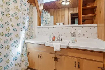 a bathroom with a sink and a mirror at Kapers - Located in a beautiful quiet area of Big Bear Lake, walking distance to Snow Summit! in Big Bear Lake