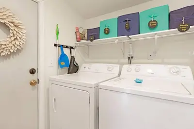 a white laundry room with a washer and dryer at The Weekender- Adorable Modern Chic Cottage in Big Bear City