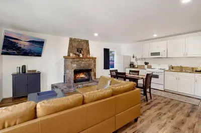 a living room with a couch and a fireplace at The Weekender- Adorable Modern Chic Cottage in Big Bear City