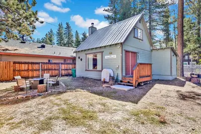 a tiny house in a yard with a fence at The Weekender- Adorable Modern Chic Cottage in Big Bear City