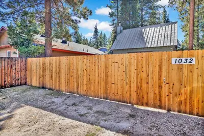 a wooden fence in front of a house at The Weekender- Adorable Modern Chic Cottage in Big Bear City
