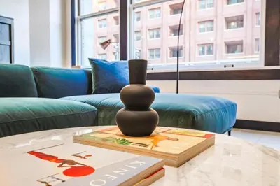 a vase sitting on a table in a living room at Stunning 1 BDR 1 BTH Modern Loft with Pool, Jacuzzi in DTLA! in Los Angeles