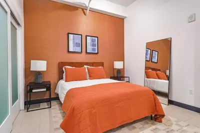 a bedroom with a large bed and a large mirror at Stunning 1 BDR 1 BTH Modern Loft with Pool, Jacuzzi in DTLA! in Los Angeles