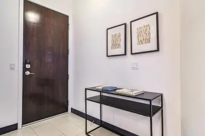 a hallway with a door and a table with books at Stunning 1 BDR 1 BTH Modern Loft with Pool, Jacuzzi in DTLA! in Los Angeles