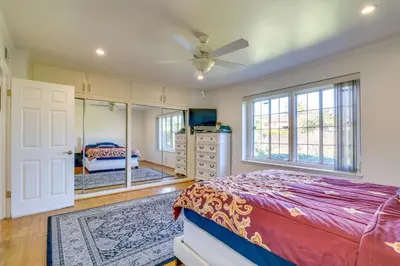 a bedroom with a bed and a dresser and a mirror at North Hills Home with Outdoor Entertaining Space in North Hills
