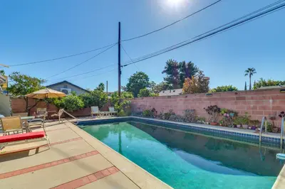 a swimming pool in the backyard of a house at North Hills Home with Outdoor Entertaining Space in North Hills
