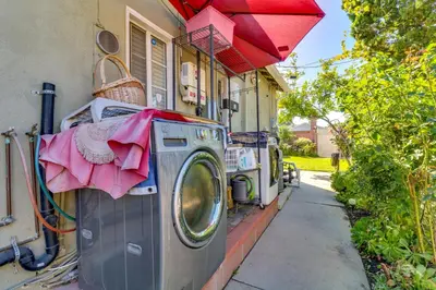 a washing machine sitting outside of a house at North Hills Home with Outdoor Entertaining Space in North Hills