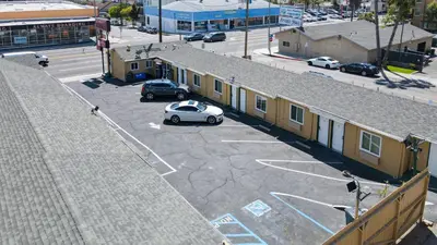 an aerial view of a parking lot with a white car at SIGNAL HILL MOTEL BEACH MOTEL in Long Beach