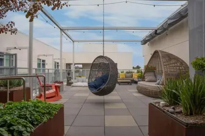 a patio with two hanging hammocks on a building at Amber Drift - Santa Monica 2BR Penthouse Ocean views in Los Angeles