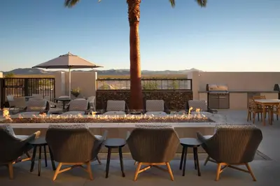 a patio with chairs and a table with lights at Fairfield by Marriott Inn & Suites Barstow in Barstow