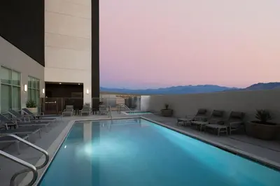 a hotel pool with chairs and a view of mountains at Fairfield by Marriott Inn & Suites Barstow in Barstow
