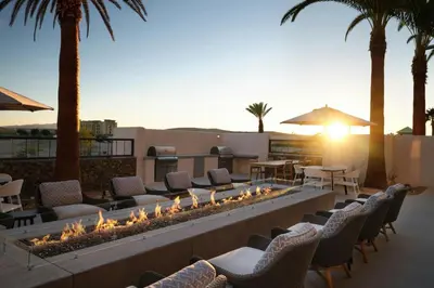a fire pit on a patio with chairs and tables at TownePlace Suites by Marriott Marriott Barstow in Barstow