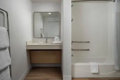 a bathroom with a sink and a tub and a mirror at TownePlace Suites by Marriott Marriott Barstow in Barstow