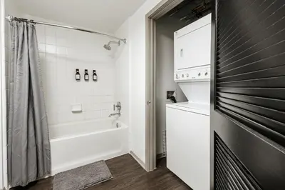a bathroom with a tub and a toilet and a sink at Oasis in heart of Hollywood in Los Angeles