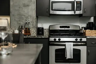 a kitchen with a stove and a microwave at Oasis in heart of Hollywood in Los Angeles