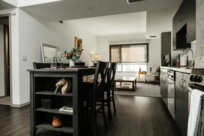 a kitchen with a counter with chairs and a table at Oasis in heart of Hollywood in Los Angeles
