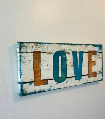 a sign that says love hanging on a wall at Spacious Studio close to LAX and close to beaches! in Gardena