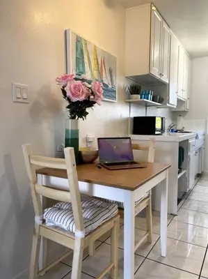 a kitchen with a table with a laptop on it at Spacious Studio close to LAX and close to beaches! in Gardena