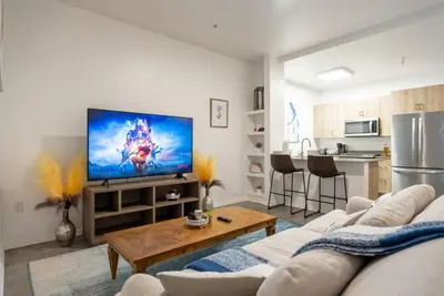 a living room with a couch and a flat screen tv at Cozy Huge LOFT for Live and Work in Los Angeles