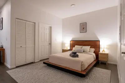 a bedroom with a bed with a teddy bear on it at Huge luxury loft for enjoying in Los Angeles