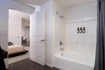 a white bathroom with a tub and a shower at Huge luxury loft for enjoying in Los Angeles
