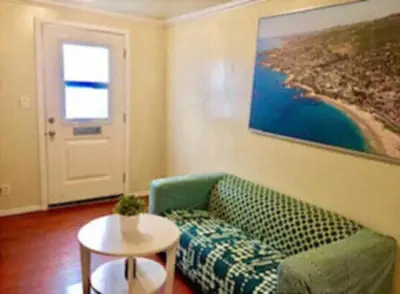 a living room with a green couch and a table at Echo Park Studio Oasis with Modern Comforts in Los Angeles