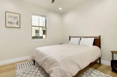 a white bedroom with a large bed and a window at The Pines Retreat- Impeccable Modern Village Chalet in Big Bear Lake
