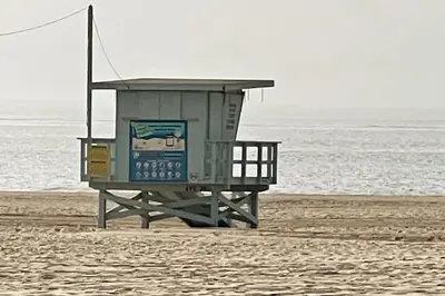 a lifeguard station on a beach with the water at House on The Beach in Los Angeles