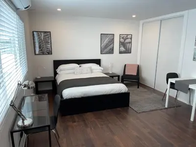 a bedroom with a bed and a desk and a desk at House on The Beach in Los Angeles