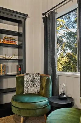 a living room with a green chair and a window at Romantic & Family Friendly Chalet In The Woods in Lake Arrowhead